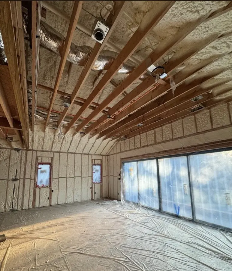 Interior walls and ceiling insulated with spray foam during new construction in Michigan City